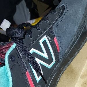 New Balance Black Sneakers with Red and Teal Highlights